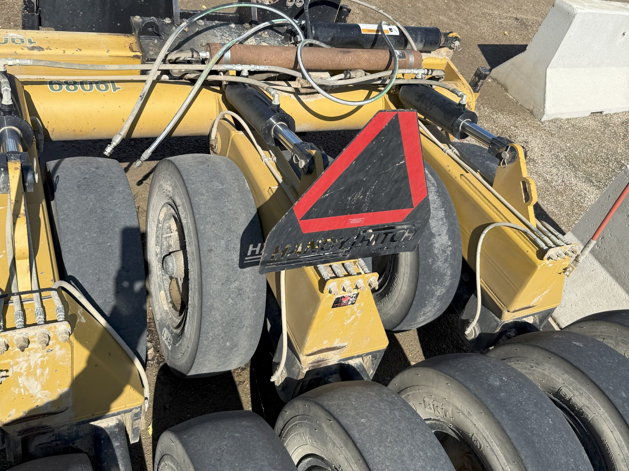   Handy Hitch 12 wheel wobbly Compactor attachment for grader at Conquest Equipment Manitoba